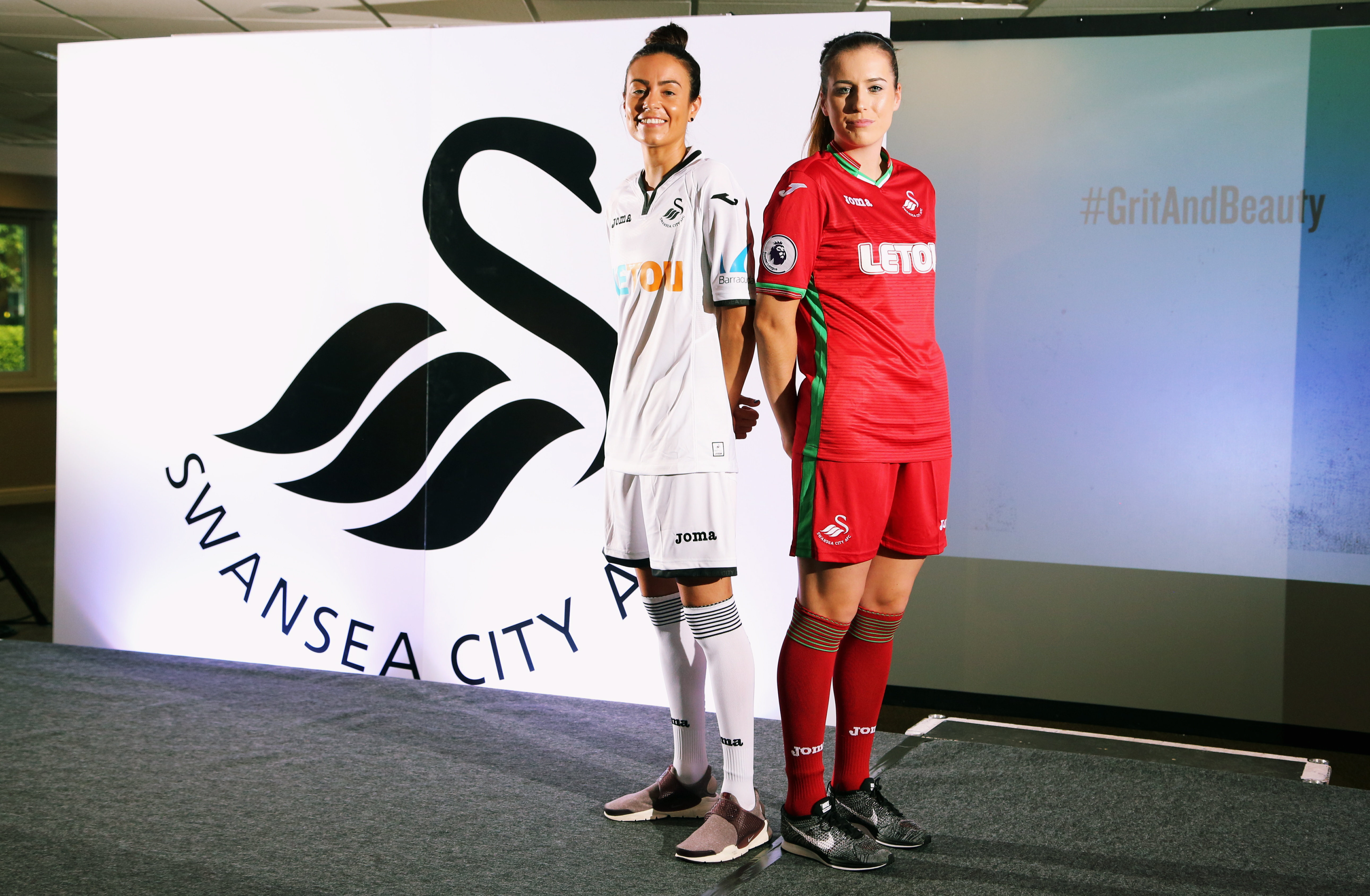 Pictured: Katy Hosford (RED) and Alicia Powe (WHITE) of the Swansea City FC Ladies' team model the home and away kits. Monday 19 June 2017 Re: Swansea City FC launch their new home and away kits and announce Letou as their new sponsor at the Liberty Stadium, Swansea, Wales, UK.
