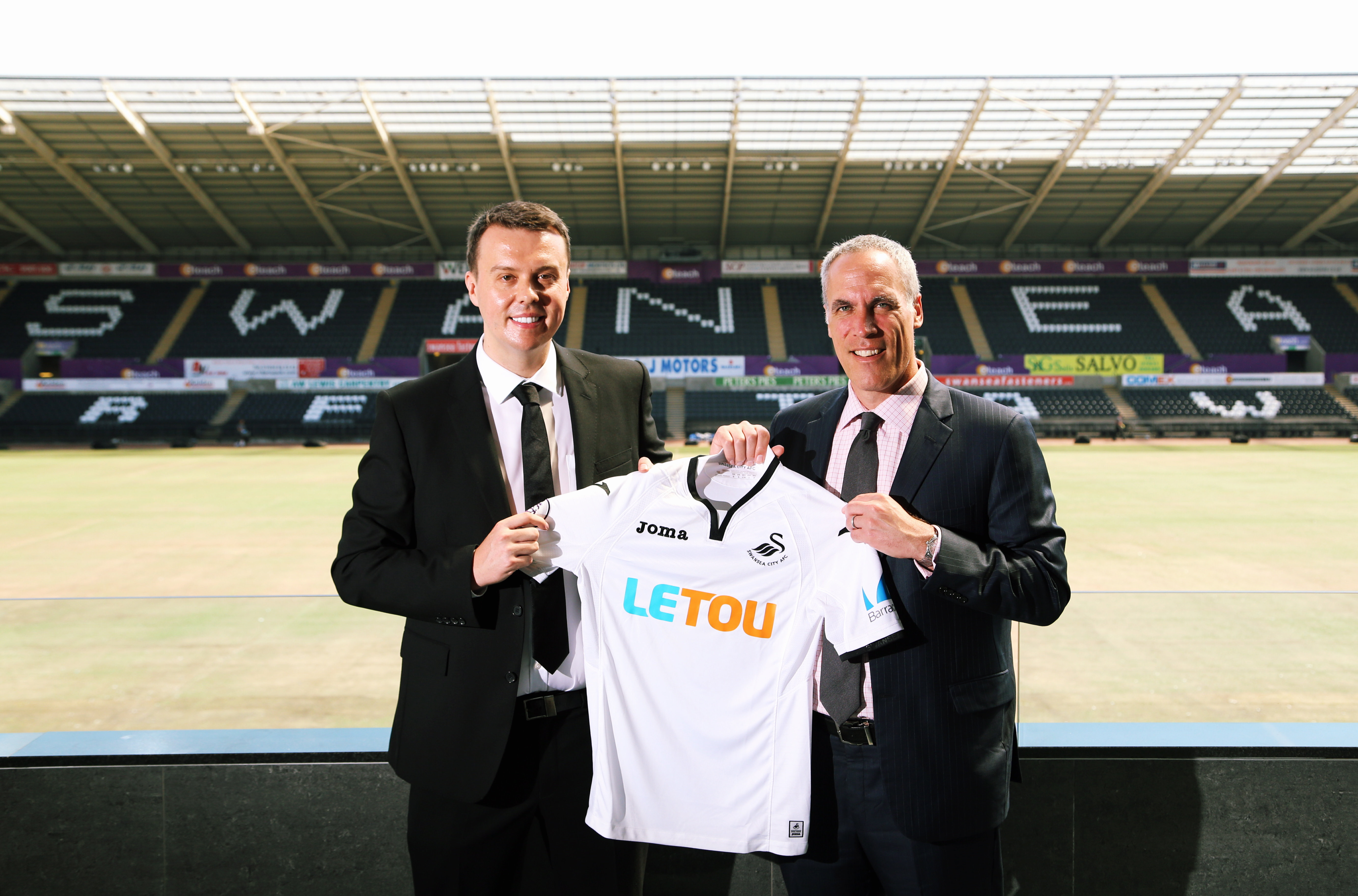 Pictured L-R: Paul Fox, CEO of Letou with Chris Pearlman, COO of Swansea City FC. Monday 19 June 2017 Re: Swansea City FC launch their new home and away kits and announce Letou as their new sponsor at the Liberty Stadium, Swansea, Wales, UK.