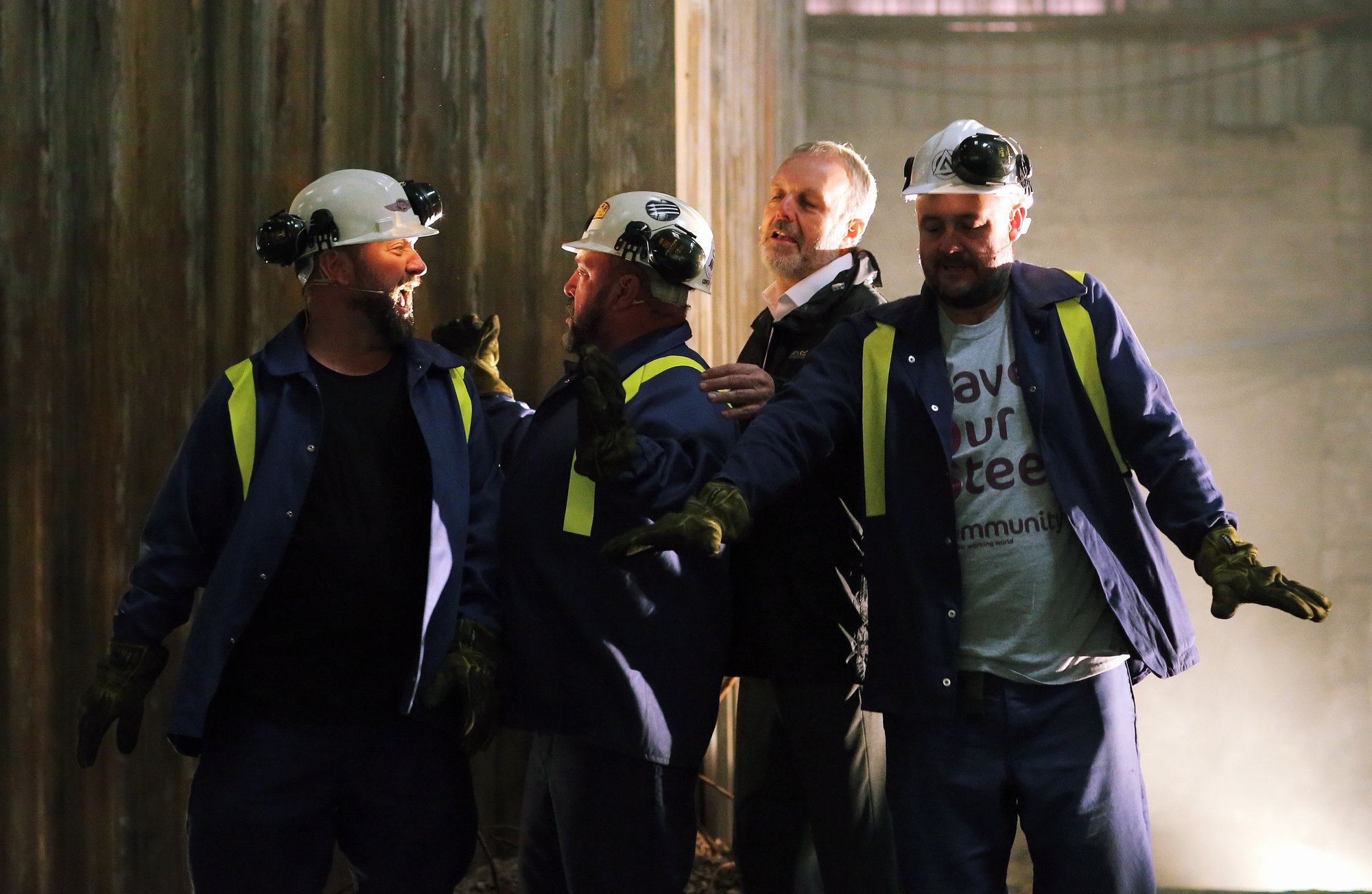 Pictured: The four main characters perform a dance scene Re: Press rehearsal of "We'Re Still Here", a play created by Rachel Trezise, Common Wealth and the National Theatre Wales about steelworkers, which will be performed in Byass Works, a disused industrial unit, in Port Talbot, south Wales, UK.