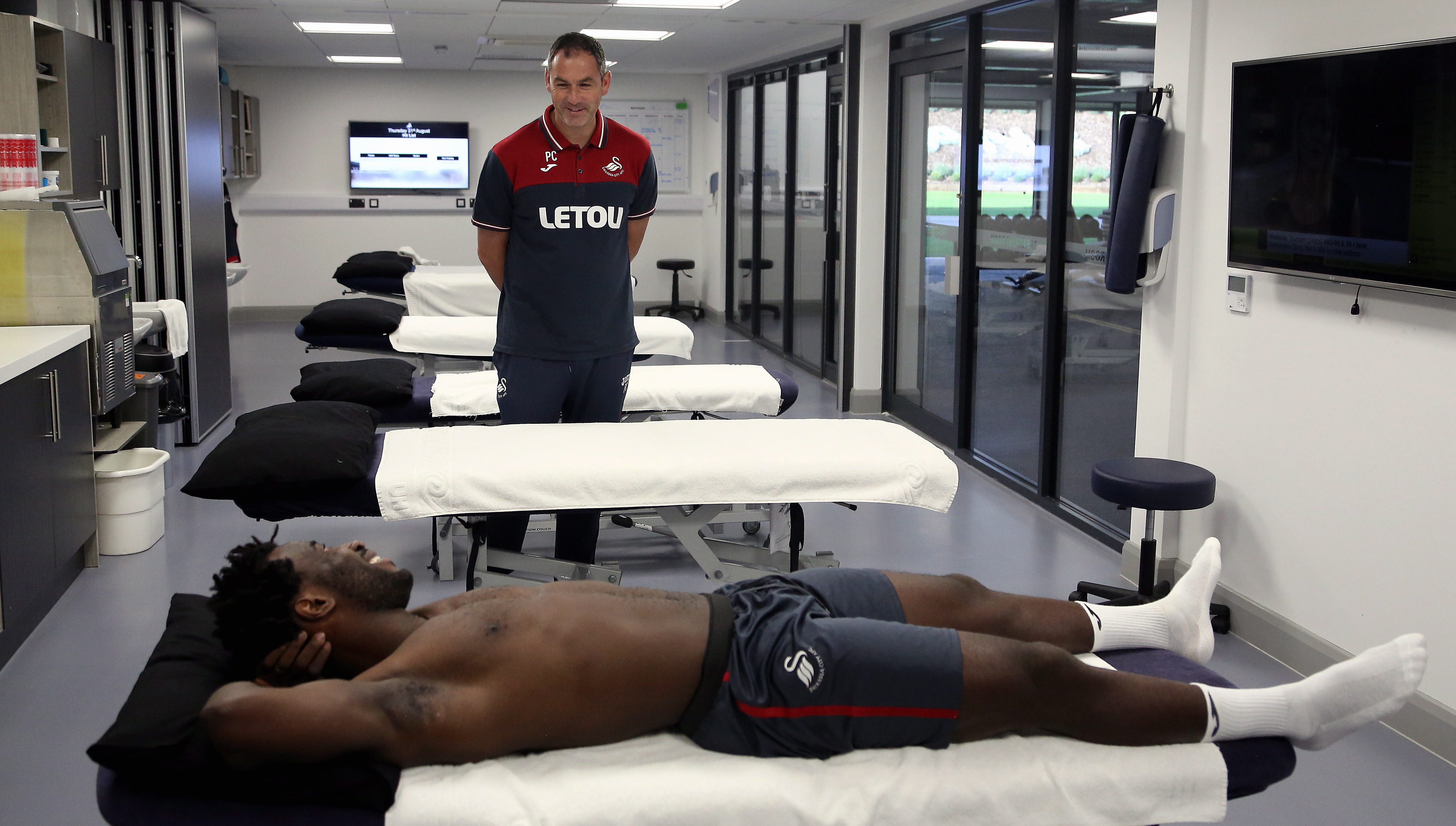 Pictured: Wilfried Bony speaks with manager Paul Clement during his medical with club physiotherapist Kate Rees at the Fairwood Training Ground, Wales, UK. Thursday 31 August 2017 Re: Wilfried Bony has signed a contract with Swansea City FC.