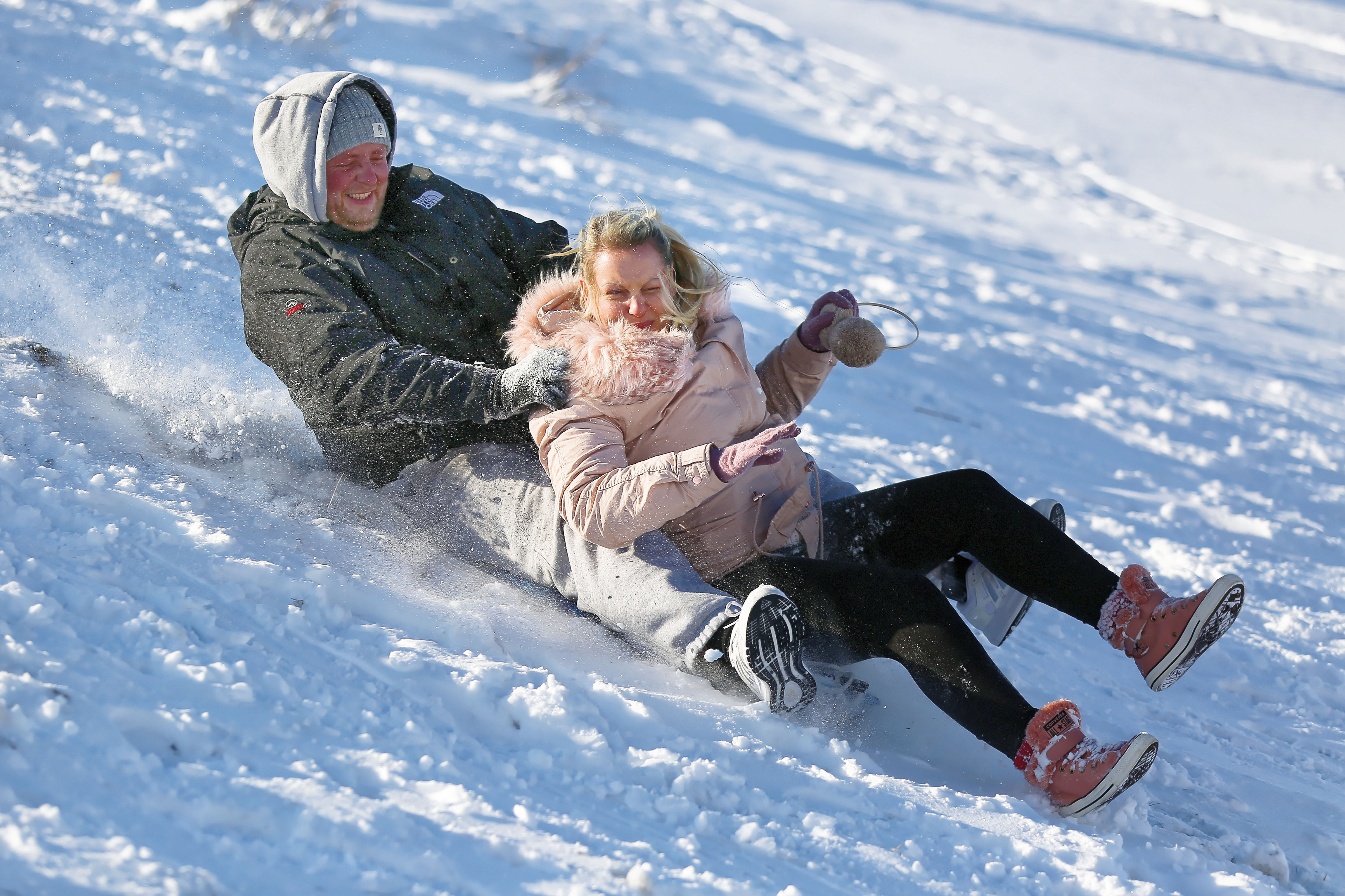 Pictured: Two adults sleigh at Storey Arms in the Brecon Beacons, Wales, UK. Monday 11 December 2017 Re: Freezing temperatures, snow and ice has affected parts of the UK.