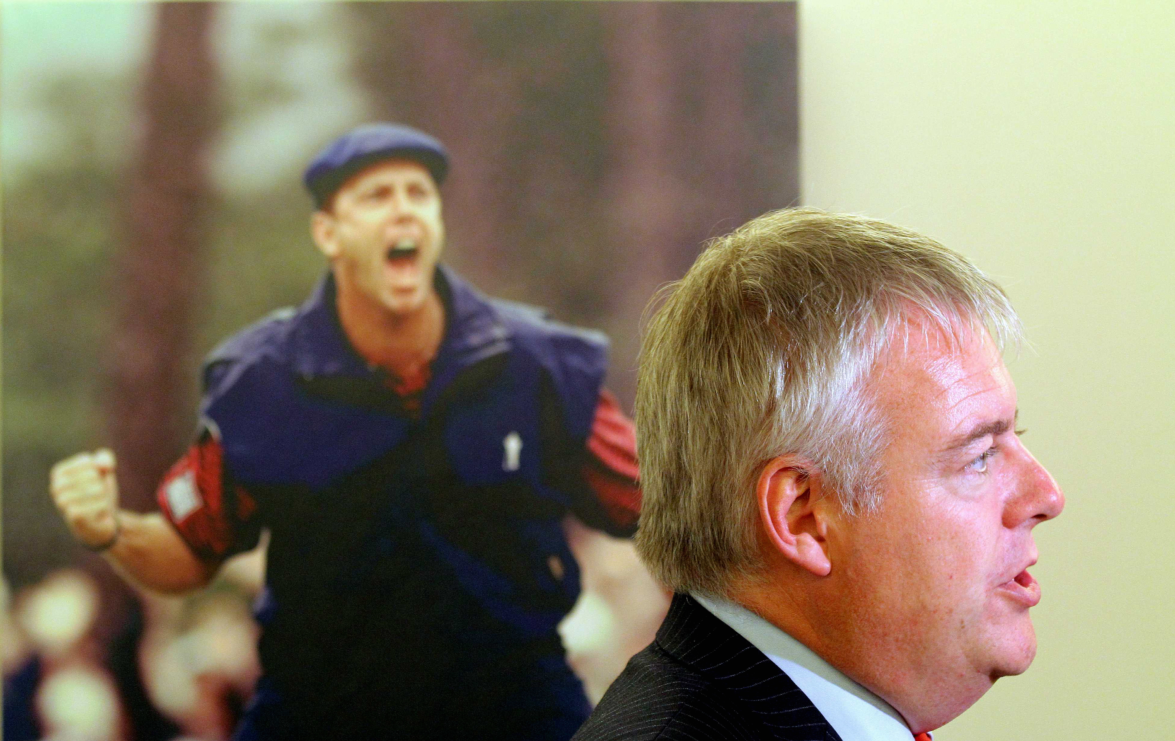 WORDS STEPHEN MOSS FOR G2 Pictured: Wales First Minister Carwyn Jones next to a picture of american golfer Payne Stewart celebrating his win on the last green of the 1999 US Open in North Carolina. Tuesday 14 September 2010 Re: The effect that the Ryder Cup 2010 which will be held at the caltic Manor resort, will have to nearby areas such as Ringland in Gwent, south Wales.