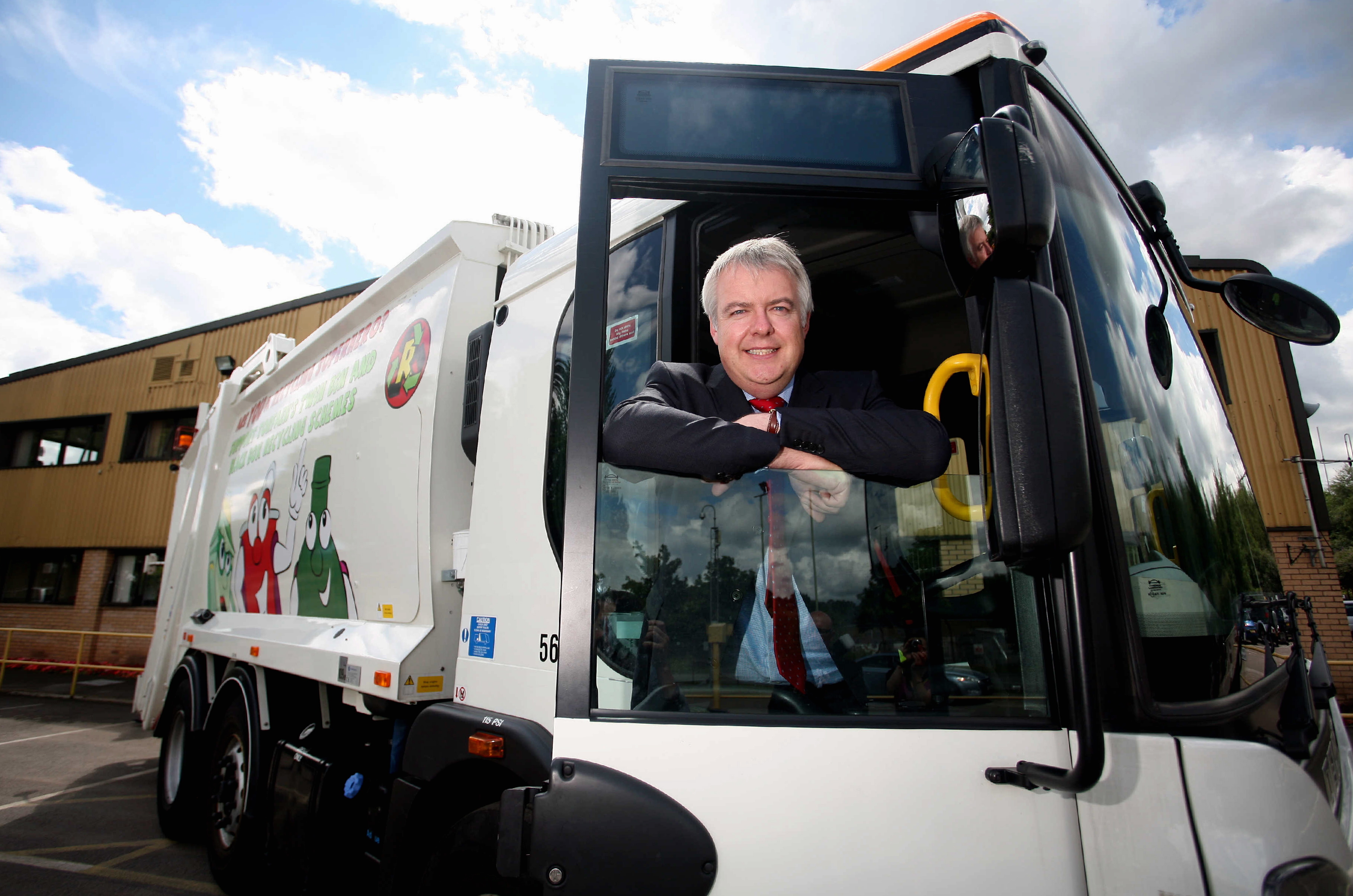 Pictured: First Minister for Wales Carwyn Jones in the cab of a refuse lorry. Thursday 22 July 2010 Re: The first minister of Wales, Carwyn Jones, is doing a tour speaking to public workers at the Neighbourhood Services department in New Inn near Pontypool where he was taken in a refuse lorry from the town's Civic Centre.