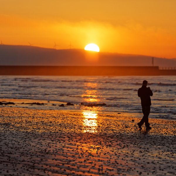 The sun rises over Swansea Bay in south Wales, UK